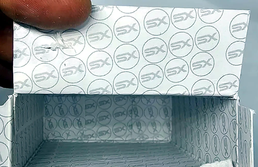 A Syntex Labs box opened to show the SX pattern printed inside