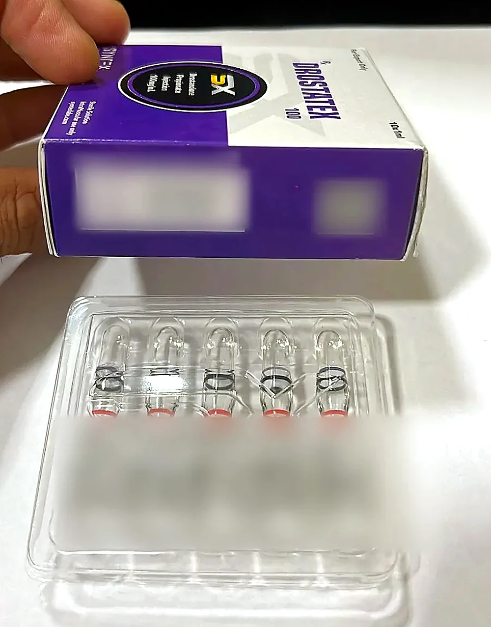 Syntex Drostatex 100 box with its tray of 10 ampoules; batch, dates, QR and code blurred